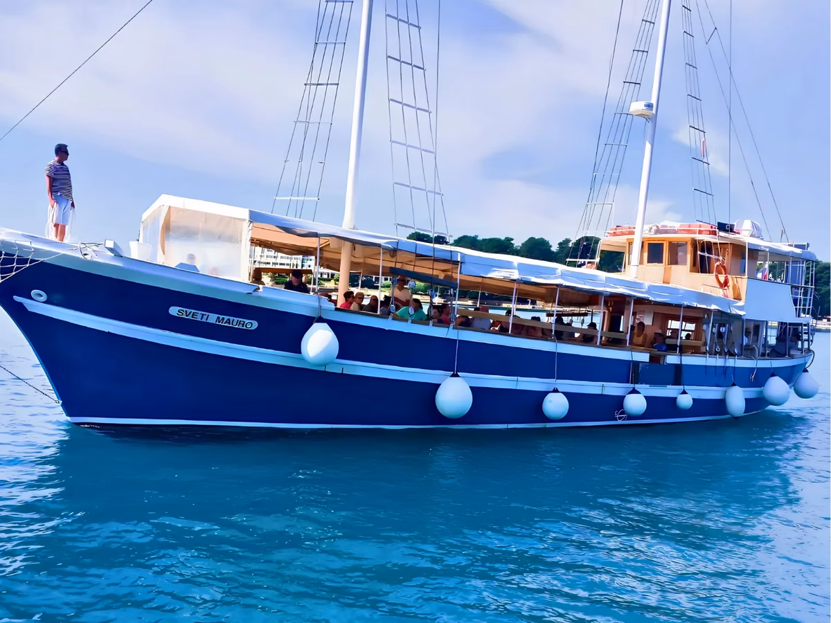 Our traditional wooden boat Sveti Mauro at anchor on the turquoise Adriatic