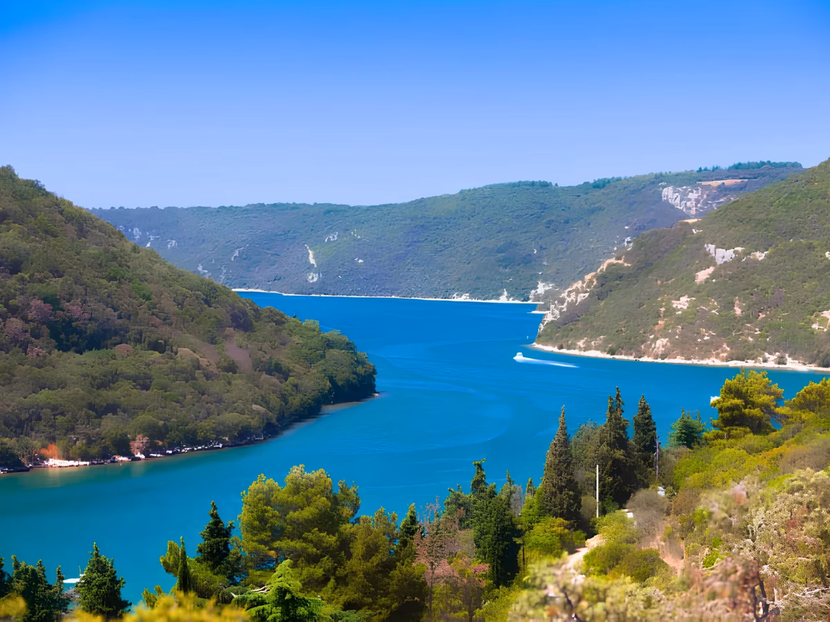 The blue waters of the Lim fjord winding between green Istrian hills